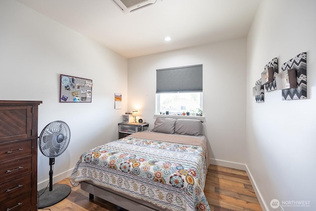 bedroom with hardwood / wood-style floors