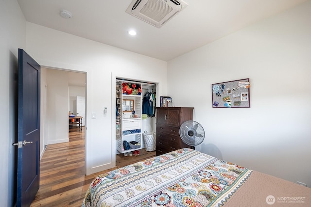 bedroom featuring a closet and dark hardwood / wood-style flooring