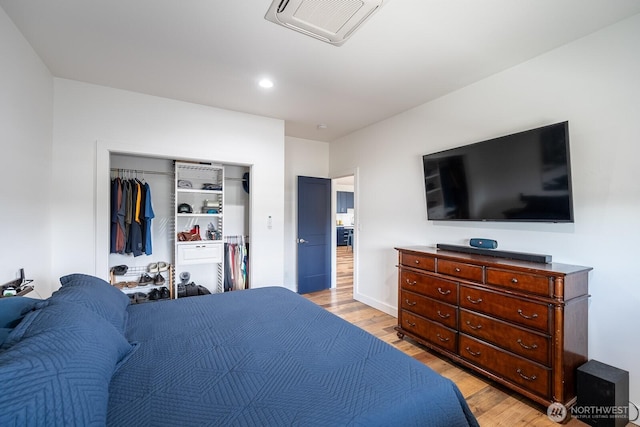 bedroom featuring light hardwood / wood-style flooring and a closet