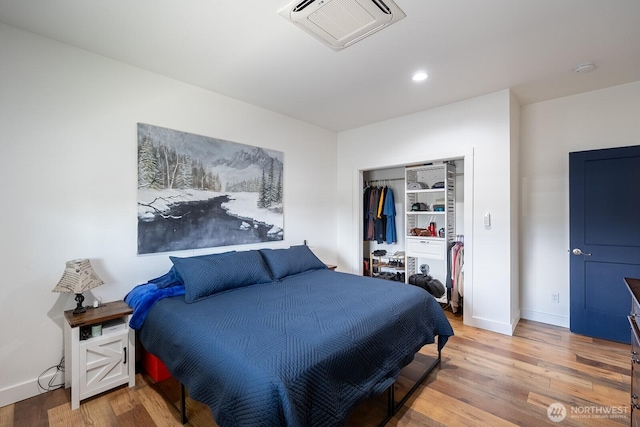 bedroom with hardwood / wood-style flooring and a closet