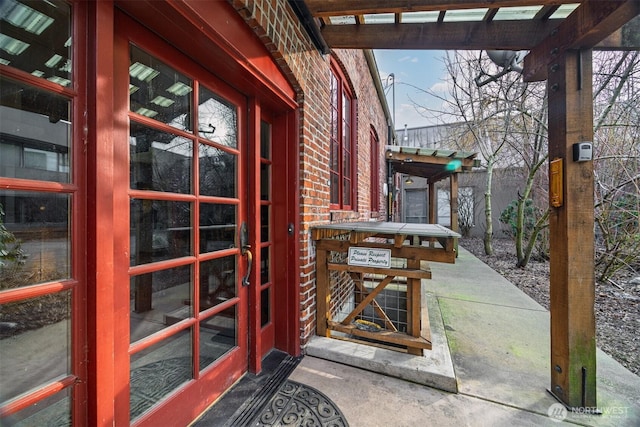 property entrance featuring brick siding