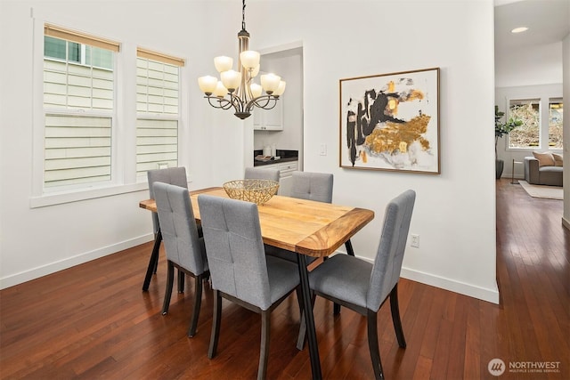 dining space with an inviting chandelier and dark wood-type flooring