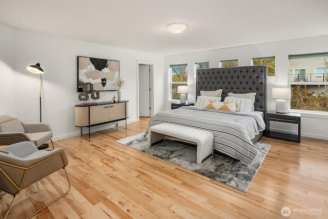 bedroom featuring hardwood / wood-style floors and multiple windows