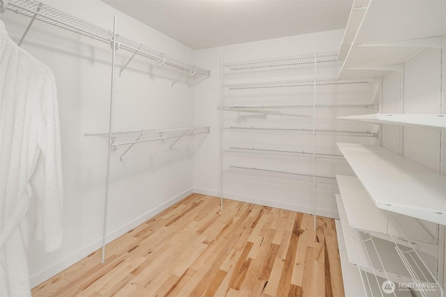 walk in closet featuring hardwood / wood-style floors