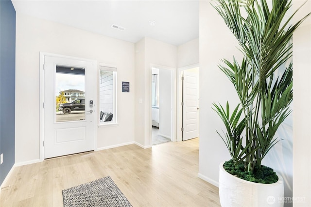 foyer entrance with light hardwood / wood-style flooring