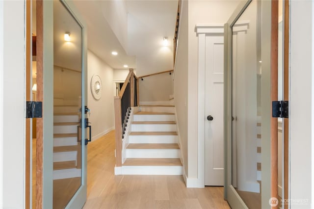 stairs with recessed lighting, baseboards, and wood finished floors