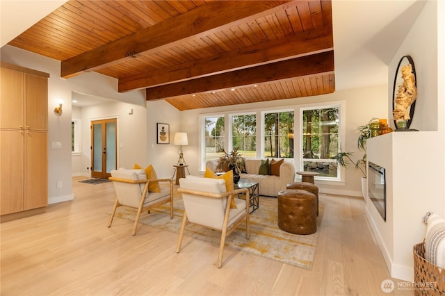 living area featuring light wood-type flooring, wood ceiling, a fireplace, and baseboards