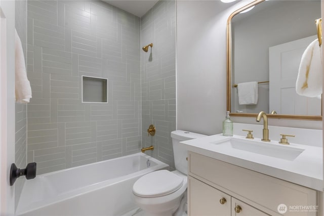 bathroom featuring washtub / shower combination, vanity, and toilet