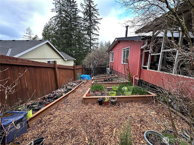 view of yard featuring a vegetable garden and a fenced backyard