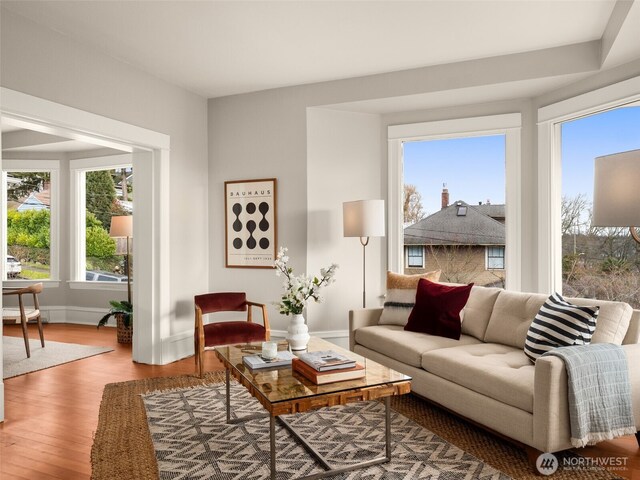 living area with wood finished floors and baseboards