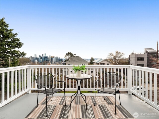 wooden terrace featuring a view of city