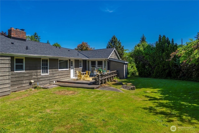 10444 16th Ave S, Seattle, WA 98168 - back of house featuring a wooden deck, a lawn, and a chimney