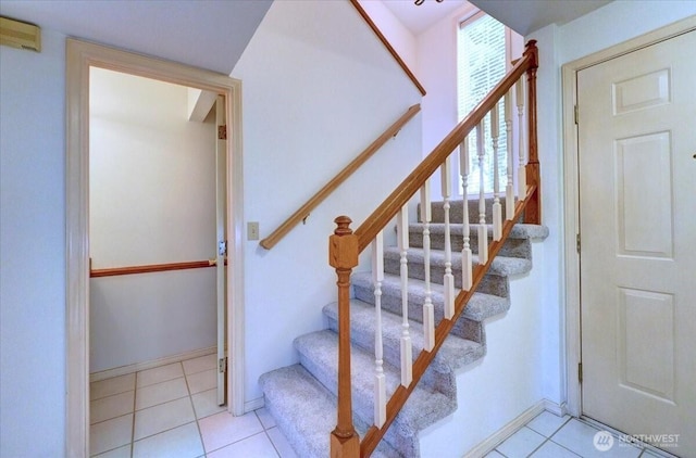 stairs featuring tile patterned flooring and baseboards