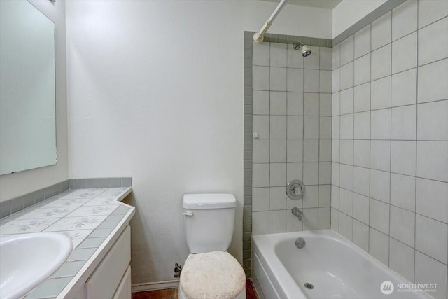 full bath featuring  shower combination, vanity, and toilet