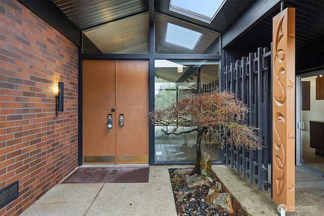 view of exterior entry featuring brick siding