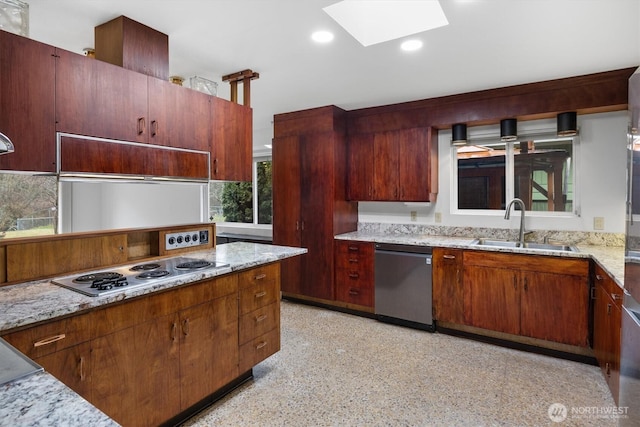 kitchen with recessed lighting, a skylight, a sink, gas stovetop, and dishwasher