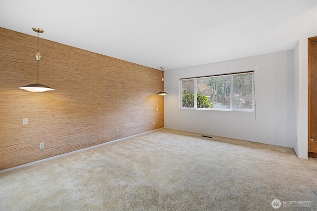 spare room with light colored carpet and visible vents