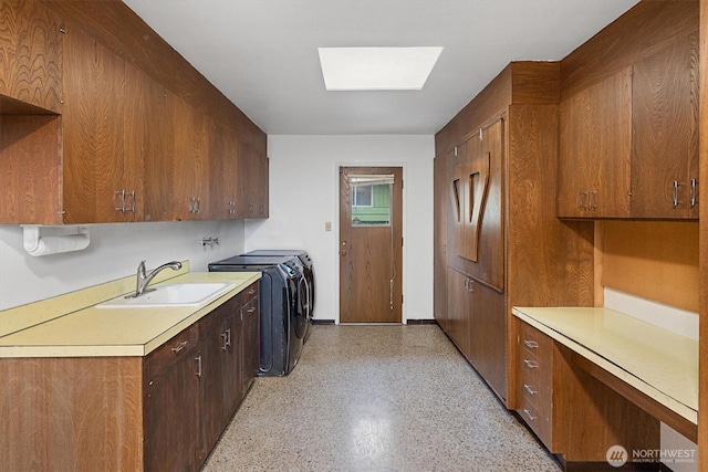 kitchen featuring a skylight, separate washer and dryer, light countertops, open shelves, and a sink