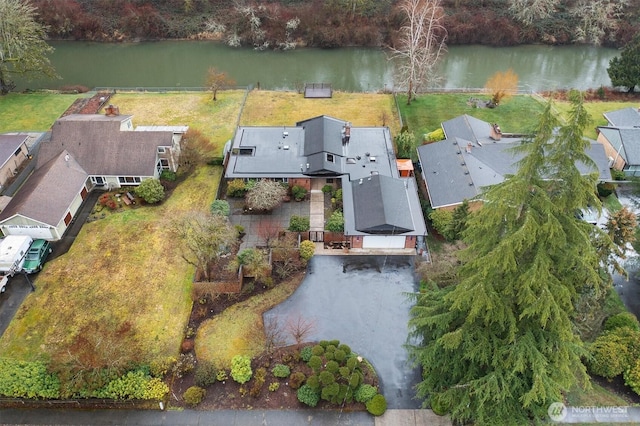 drone / aerial view with a water view and a residential view