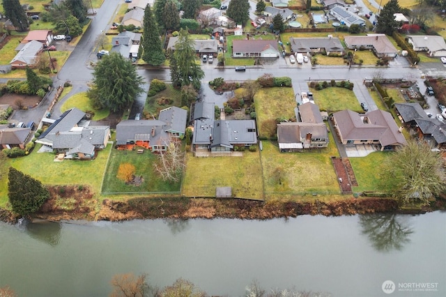 drone / aerial view with a residential view and a water view