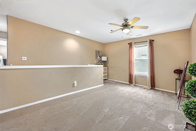 unfurnished room with light carpet and ceiling fan