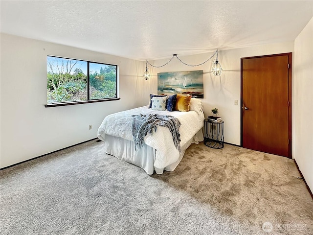 carpeted bedroom featuring a textured ceiling