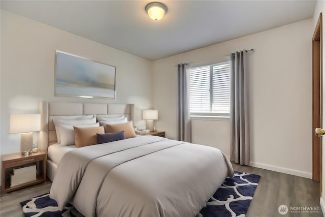 bedroom featuring baseboards and wood finished floors