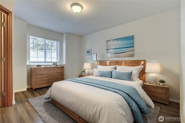 bedroom with baseboards and wood finished floors