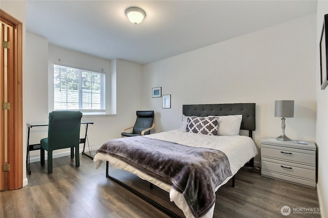 bedroom with baseboards and wood finished floors