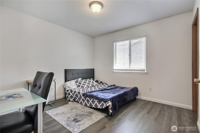 bedroom with baseboards and wood finished floors