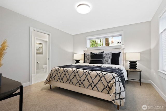 carpeted bedroom featuring ensuite bath