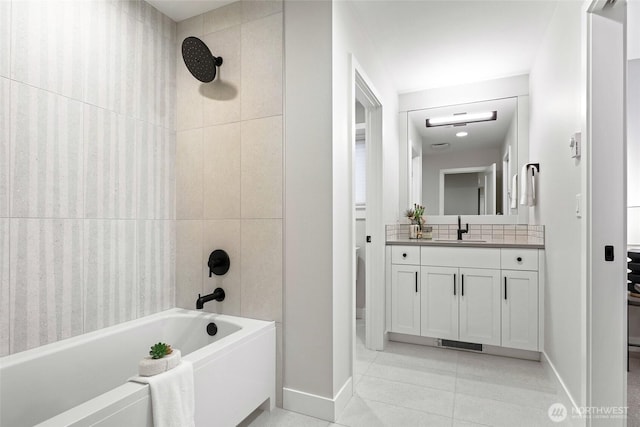 bathroom with vanity, tile patterned flooring, and tiled shower / bath combo