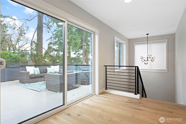 doorway featuring hardwood / wood-style floors and an inviting chandelier