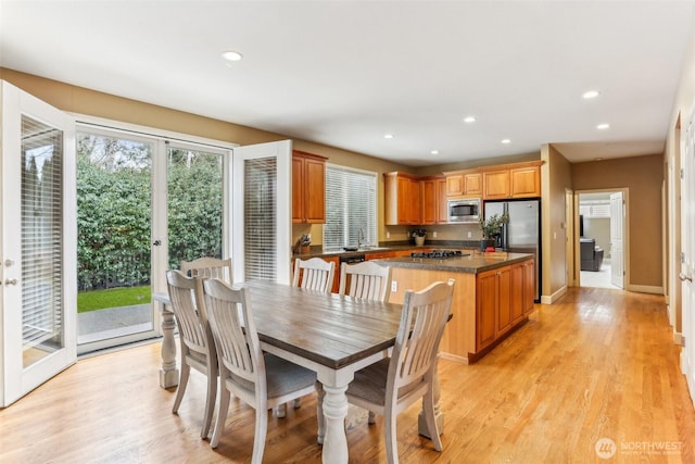 dining room with light wood-style flooring, baseboards, and recessed lighting