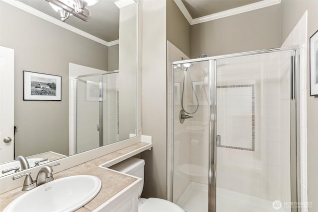 full bath featuring toilet, a stall shower, vanity, and crown molding