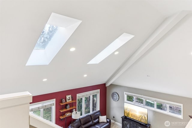 living area featuring vaulted ceiling with skylight, plenty of natural light, and recessed lighting