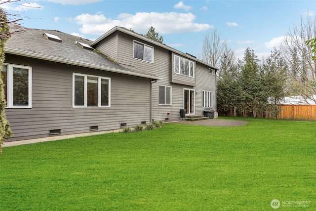 back of property featuring crawl space, a shingled roof, fence, and a yard