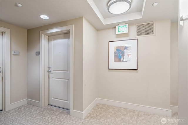 hallway featuring light colored carpet