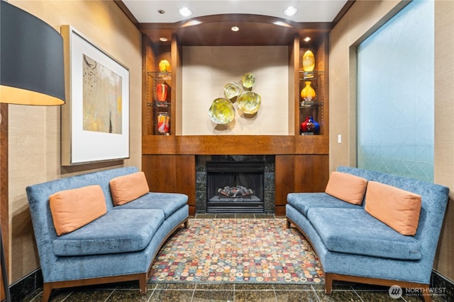 sitting room featuring built in shelves and a fireplace