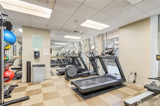 gym with a paneled ceiling