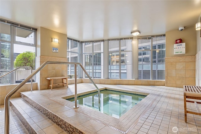 view of pool with an indoor hot tub