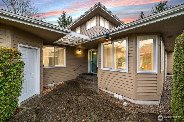 property exterior at dusk featuring entry steps