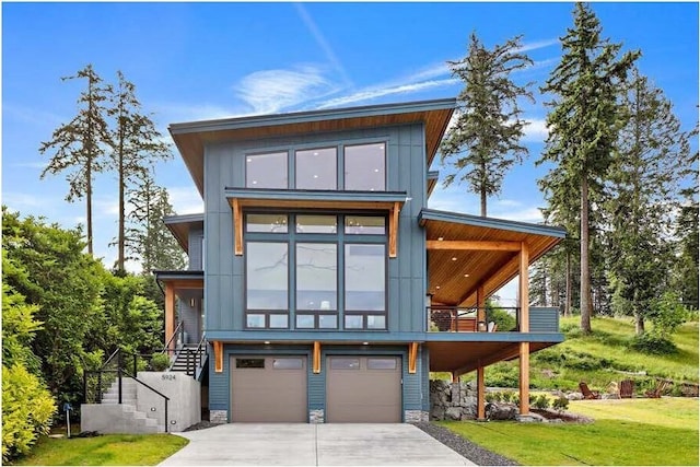 contemporary house featuring an attached garage, concrete driveway, and board and batten siding