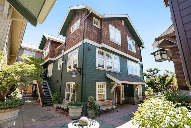 back of house featuring a patio area and stairway