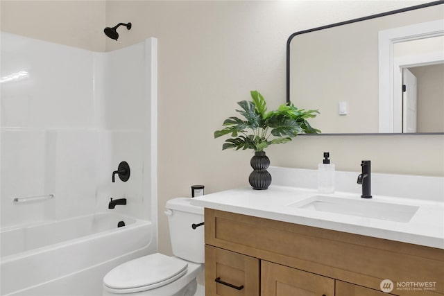 full bathroom featuring vanity, bathing tub / shower combination, and toilet