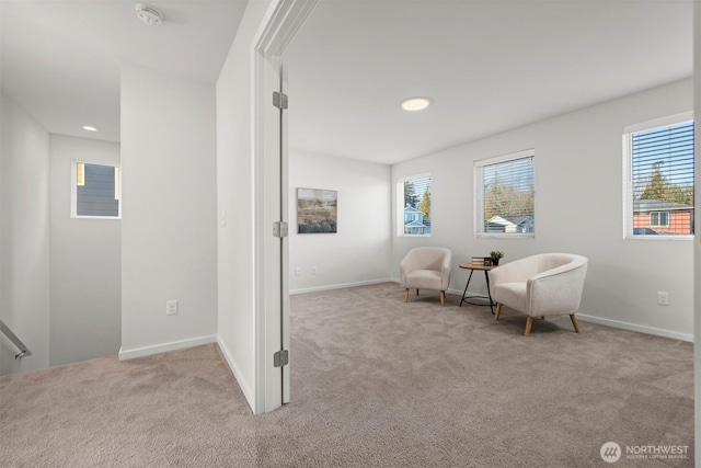 living area with recessed lighting, baseboards, and light colored carpet