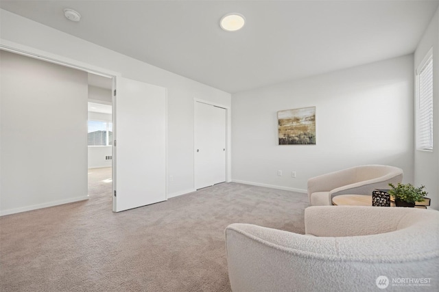 living room featuring light carpet, plenty of natural light, and baseboards