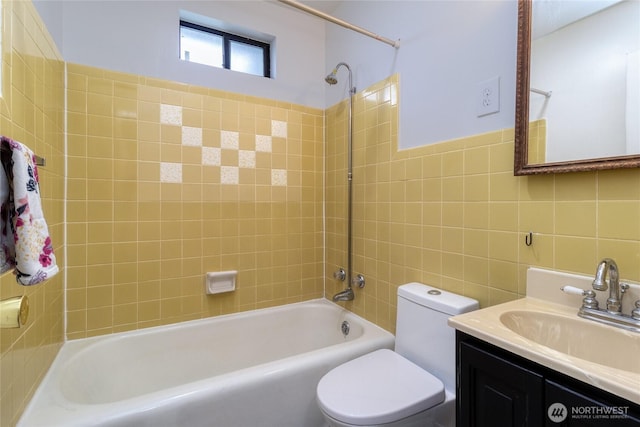 full bathroom featuring shower / bathing tub combination, tile walls, toilet, and vanity