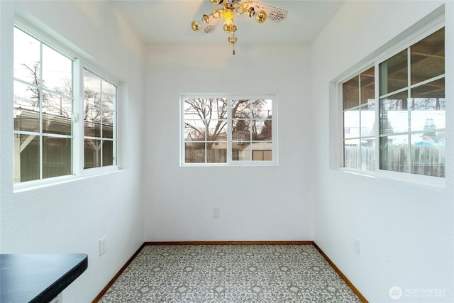 unfurnished dining area featuring carpet and baseboards