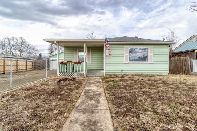 bungalow-style house with a porch and fence